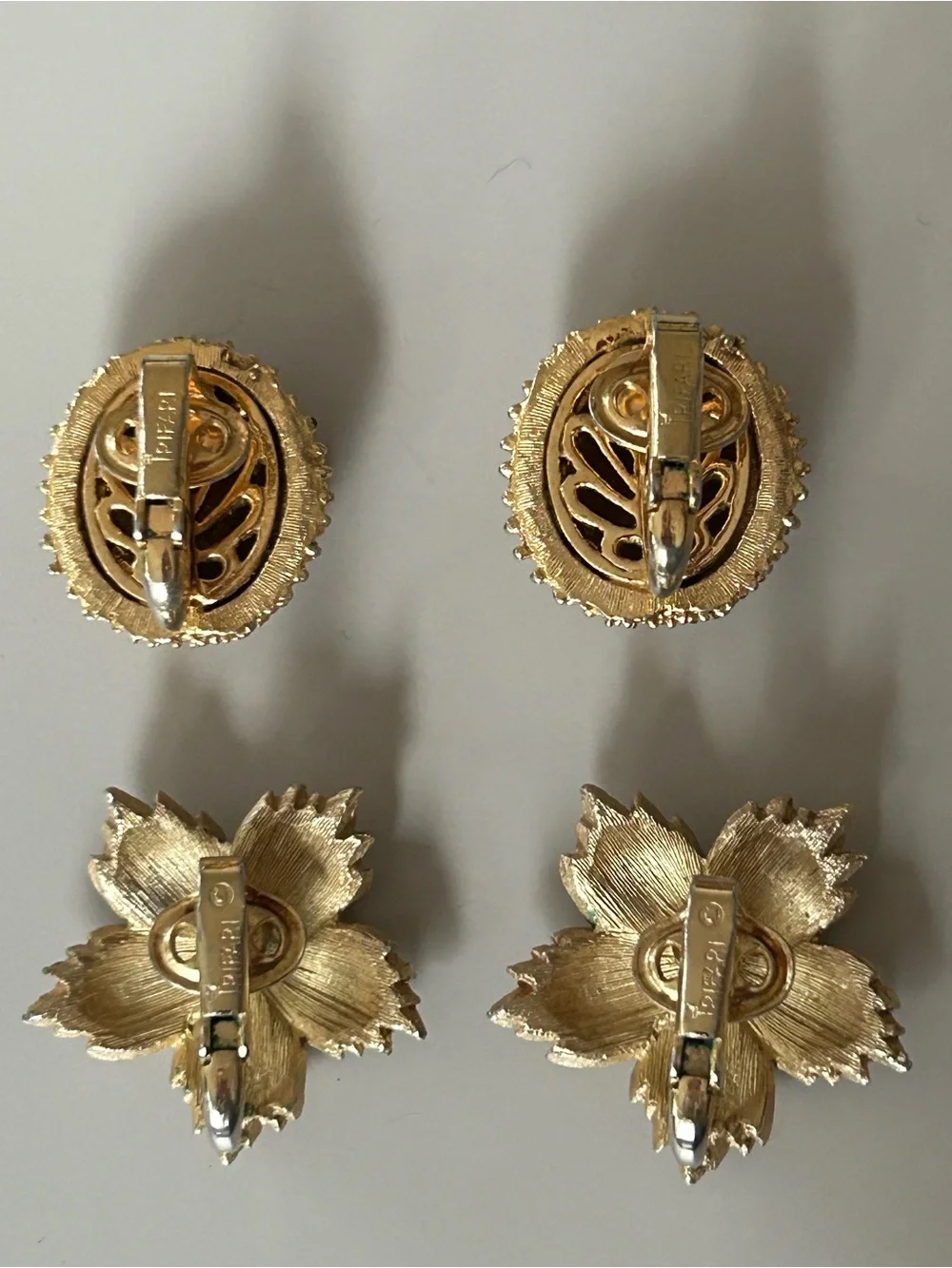 2 pairs of #CrownTrifari Clip-on Earrings. Gold-Tone Ribbed Domes and Florals.